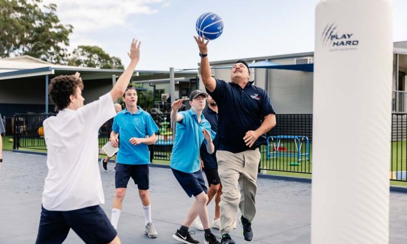 A weekly basketball game in progress, showcasing friendly competition between staff and students.