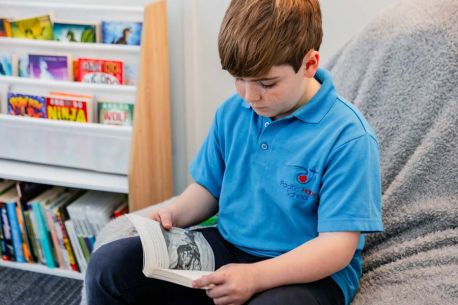 A student having a quiet moment while reading a book.